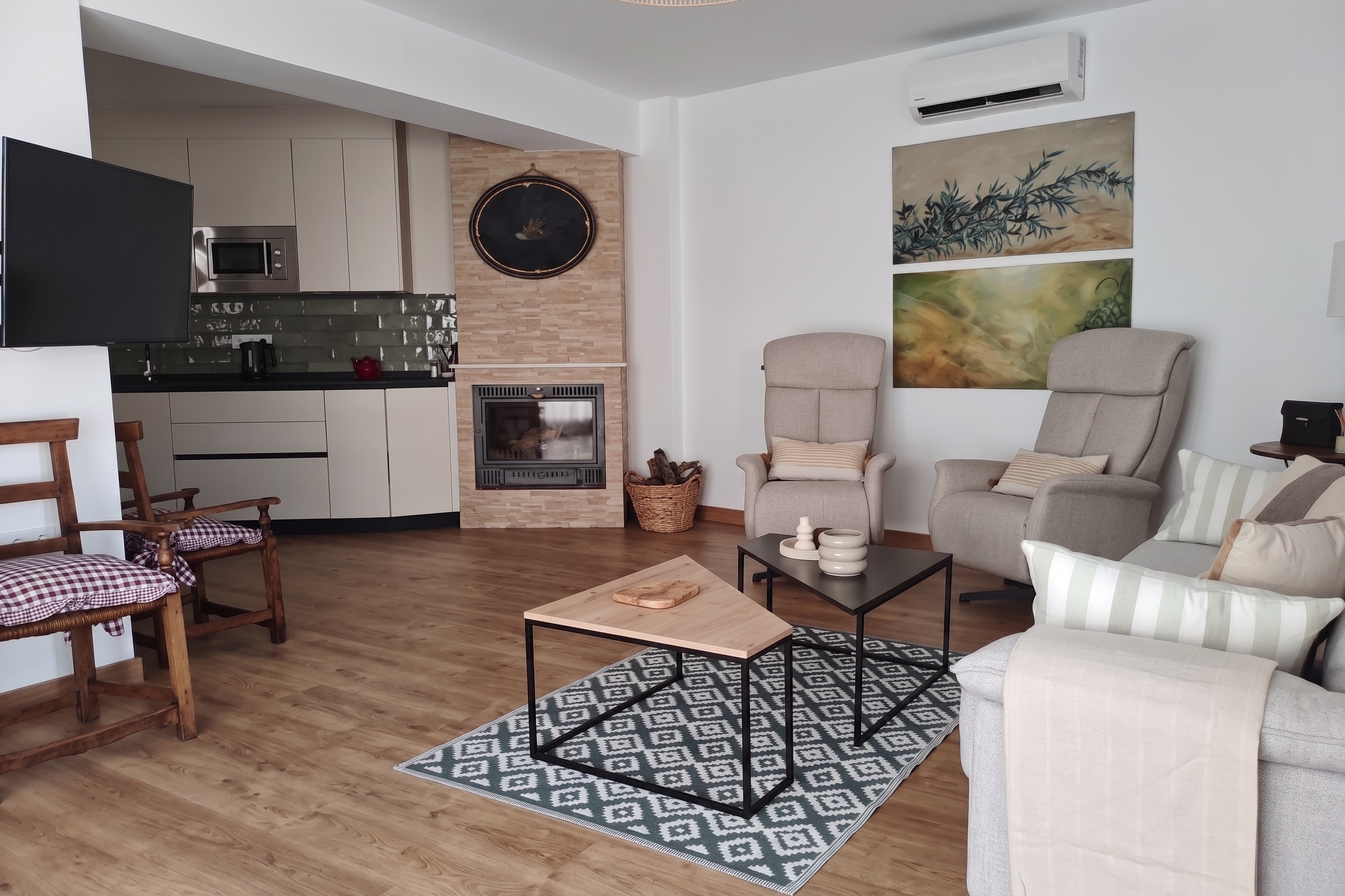 Salón de El Principal: chimenea, cocina abierta y sillones